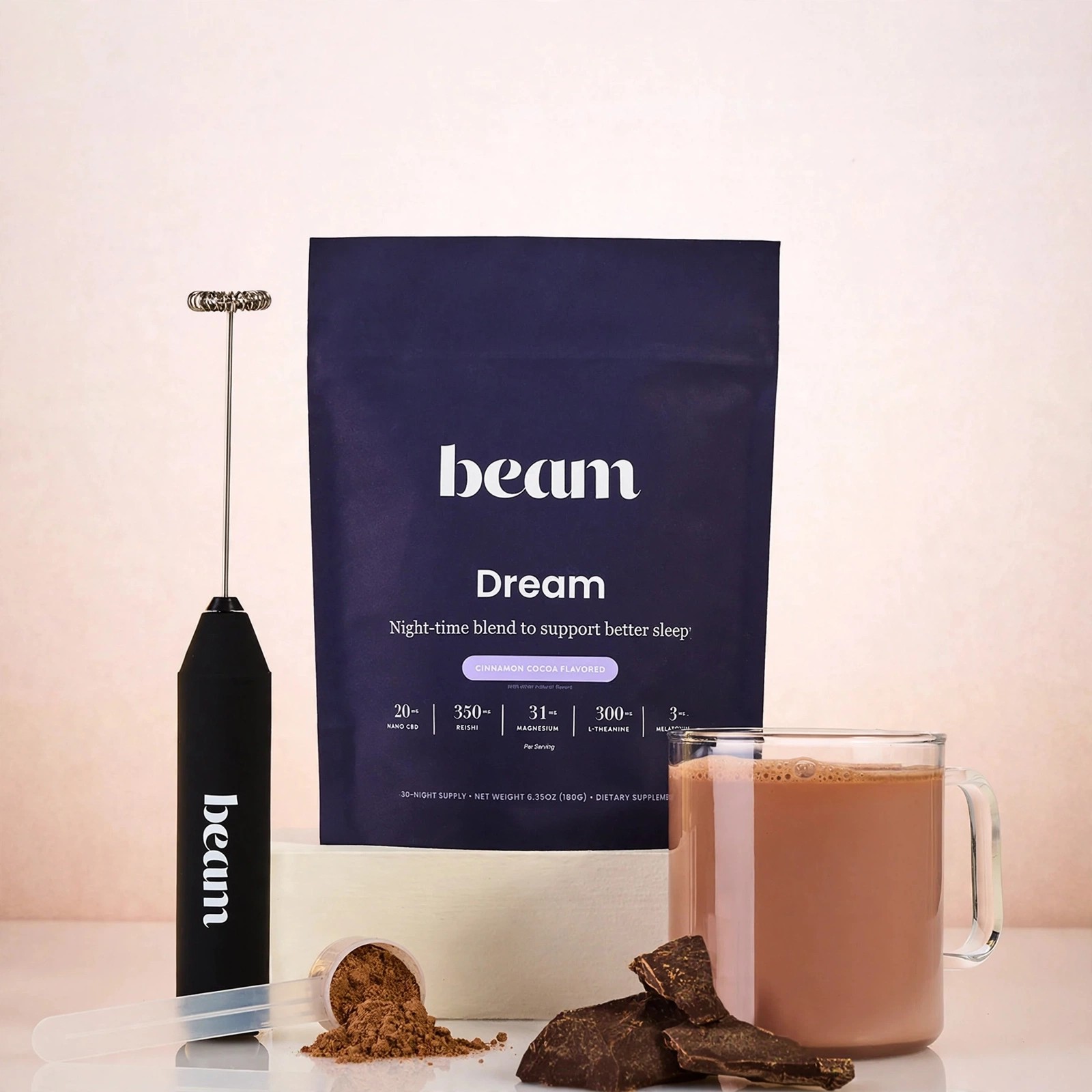 Styled setup showing Dream powder, hot cocoa and chocolate chunks.