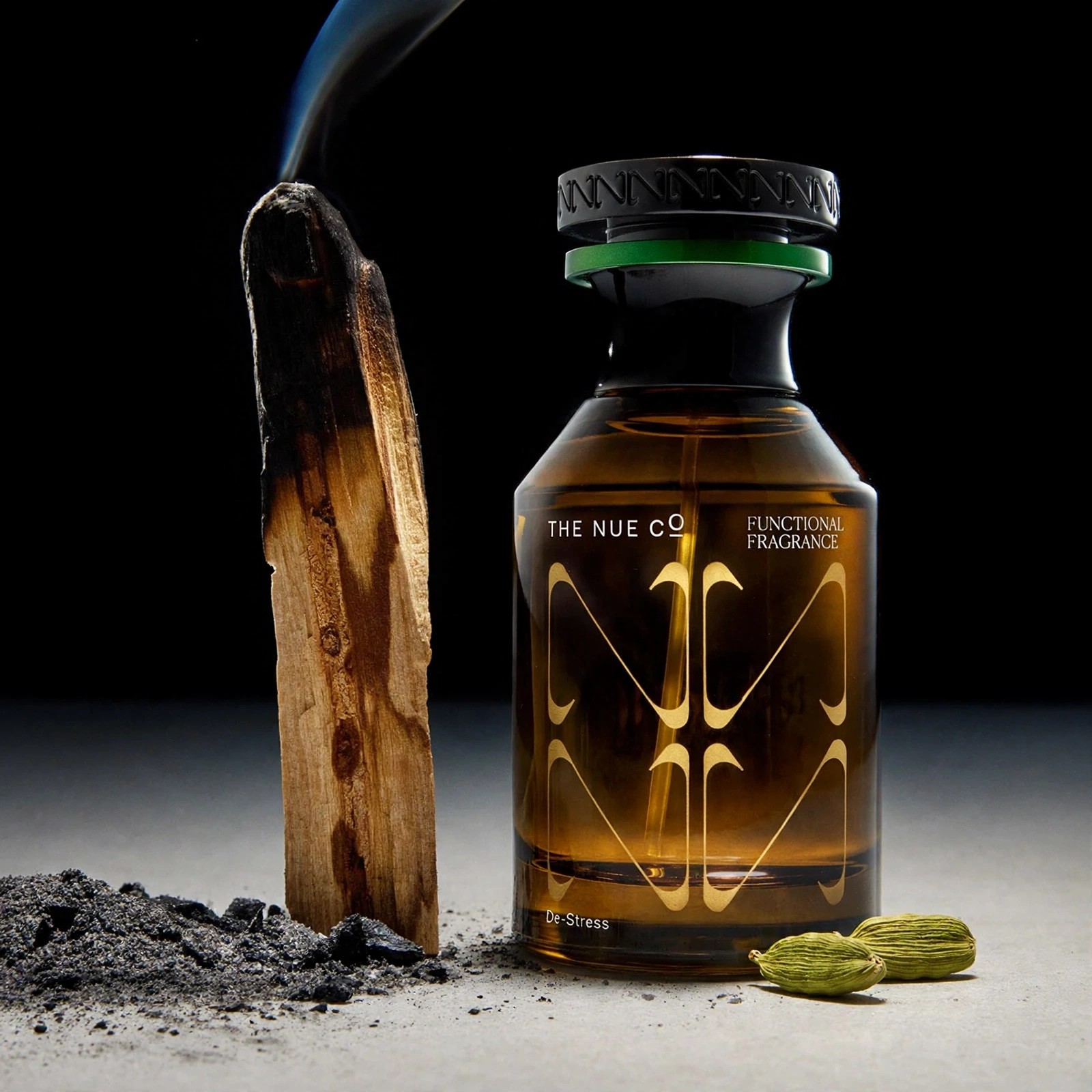 Dark still life pairing fragrance with natural elements.